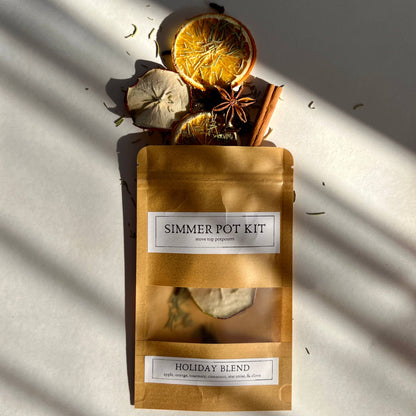 Simmer pot kit with dried fruits and spices on a textured surface