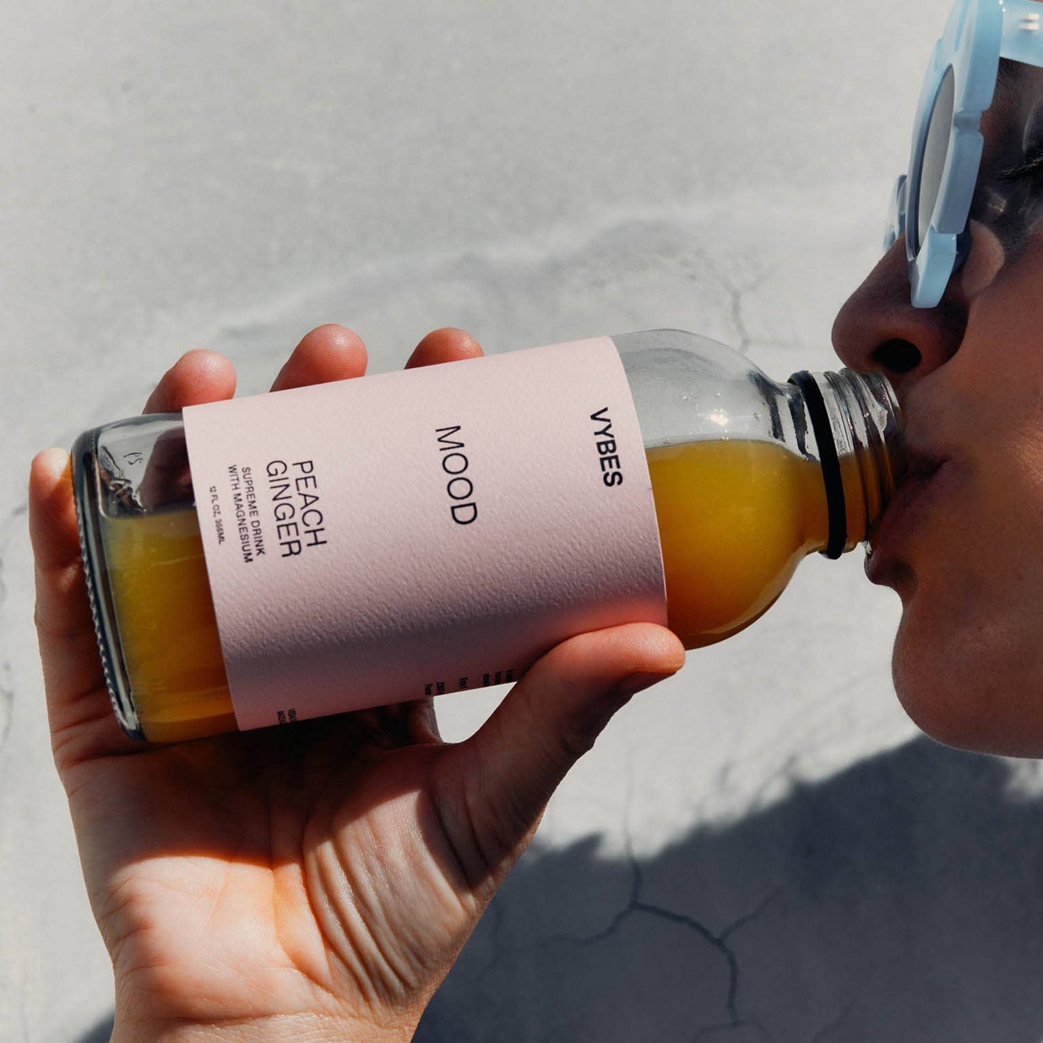 Person holding a bottle of &