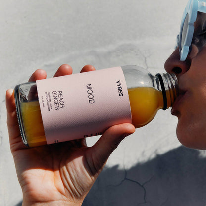 Person holding a bottle of &