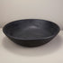 Arendal black mango wood bowl on a white surface with a plain background