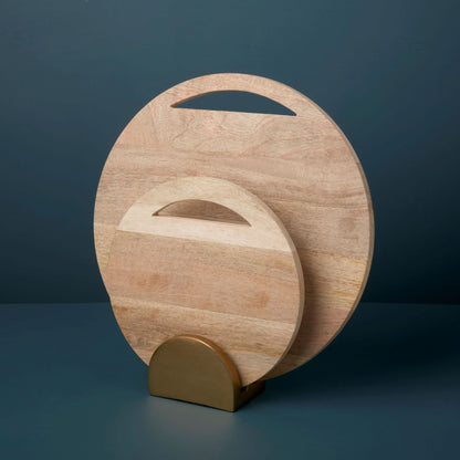 Set of two round wooden boards on a gold stand on a dark blue background