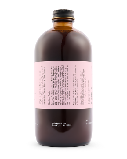 Brown bottle with a pink label on a white background