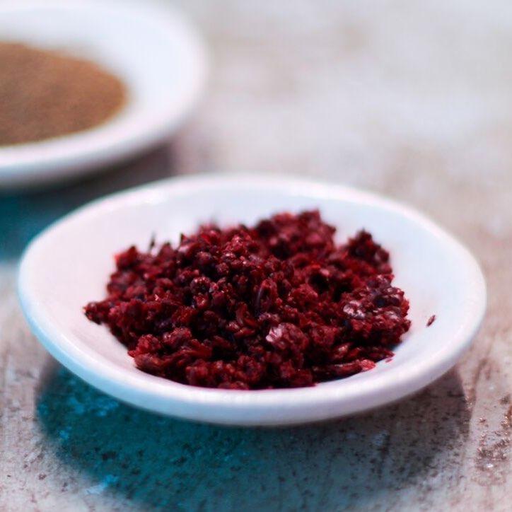 A white dish filled with cured sumac