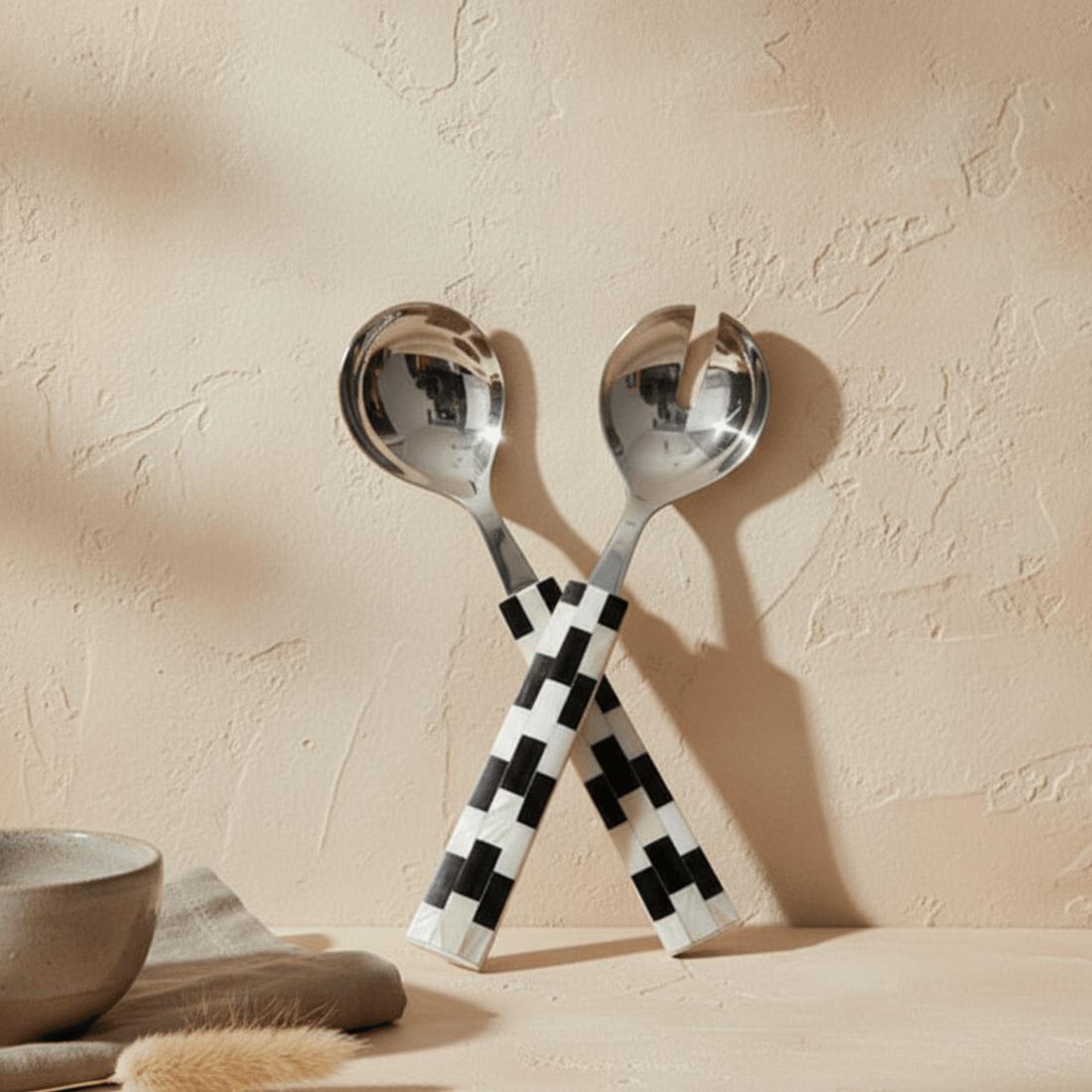 Finlay Inlay serving set with checkered handles on a beige surface