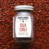 Jar of Burlap & Barrel Silk Chili spice on a bed of red chili flakes