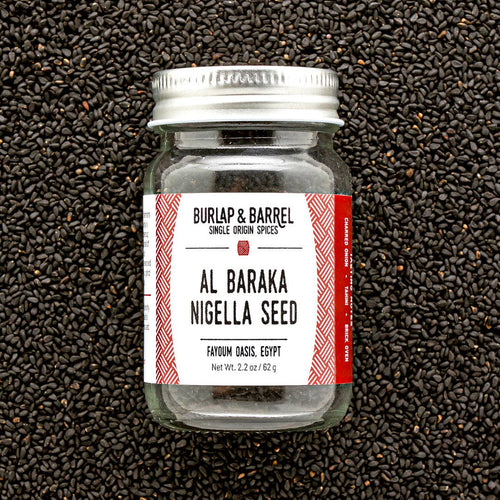 Jar of Burlap & Barrel Al Baraka Nigella Seed on a black seed background