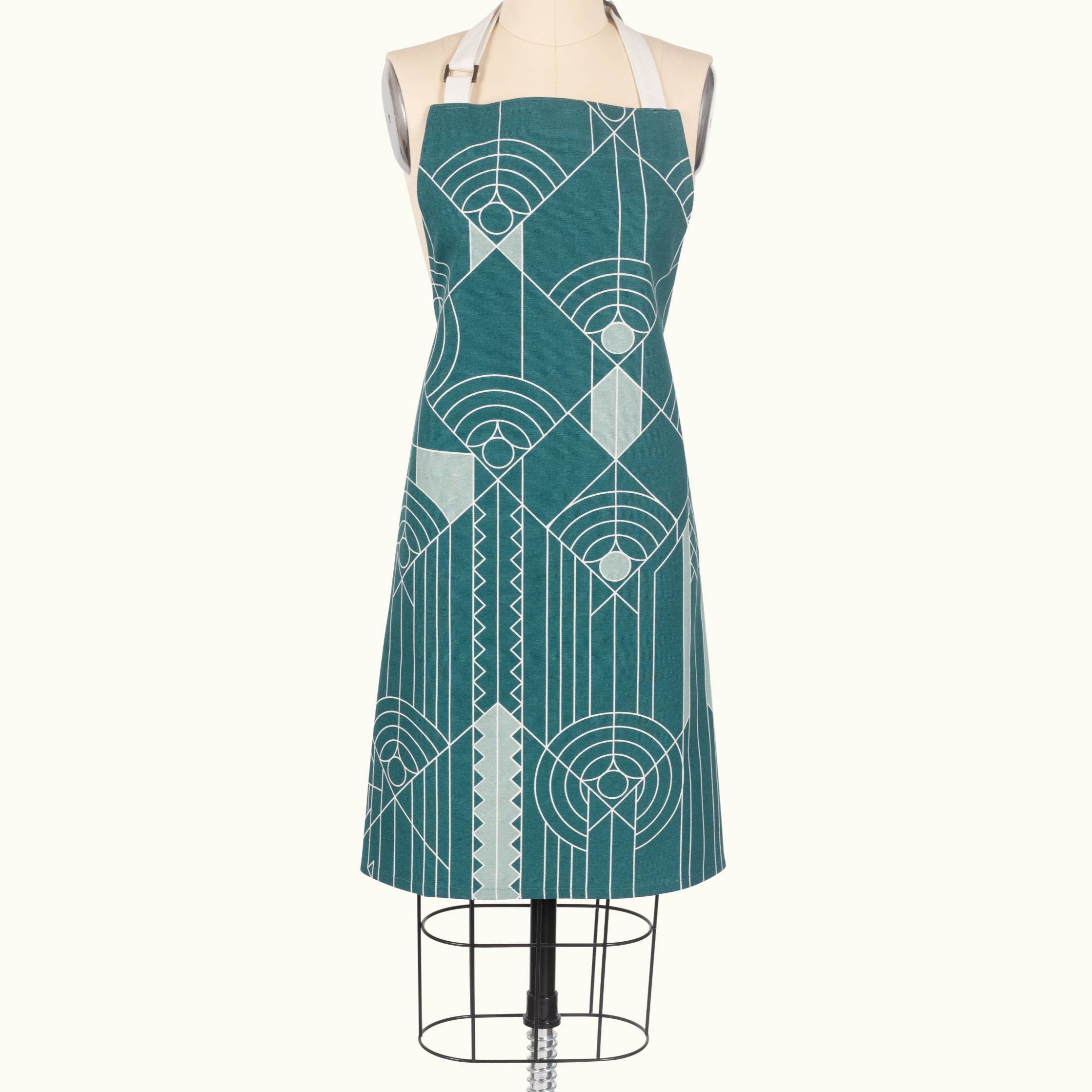 Teal apron with geometric pattern on a mannequin against a white background