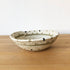 Woven basket on a wooden surface with a white background