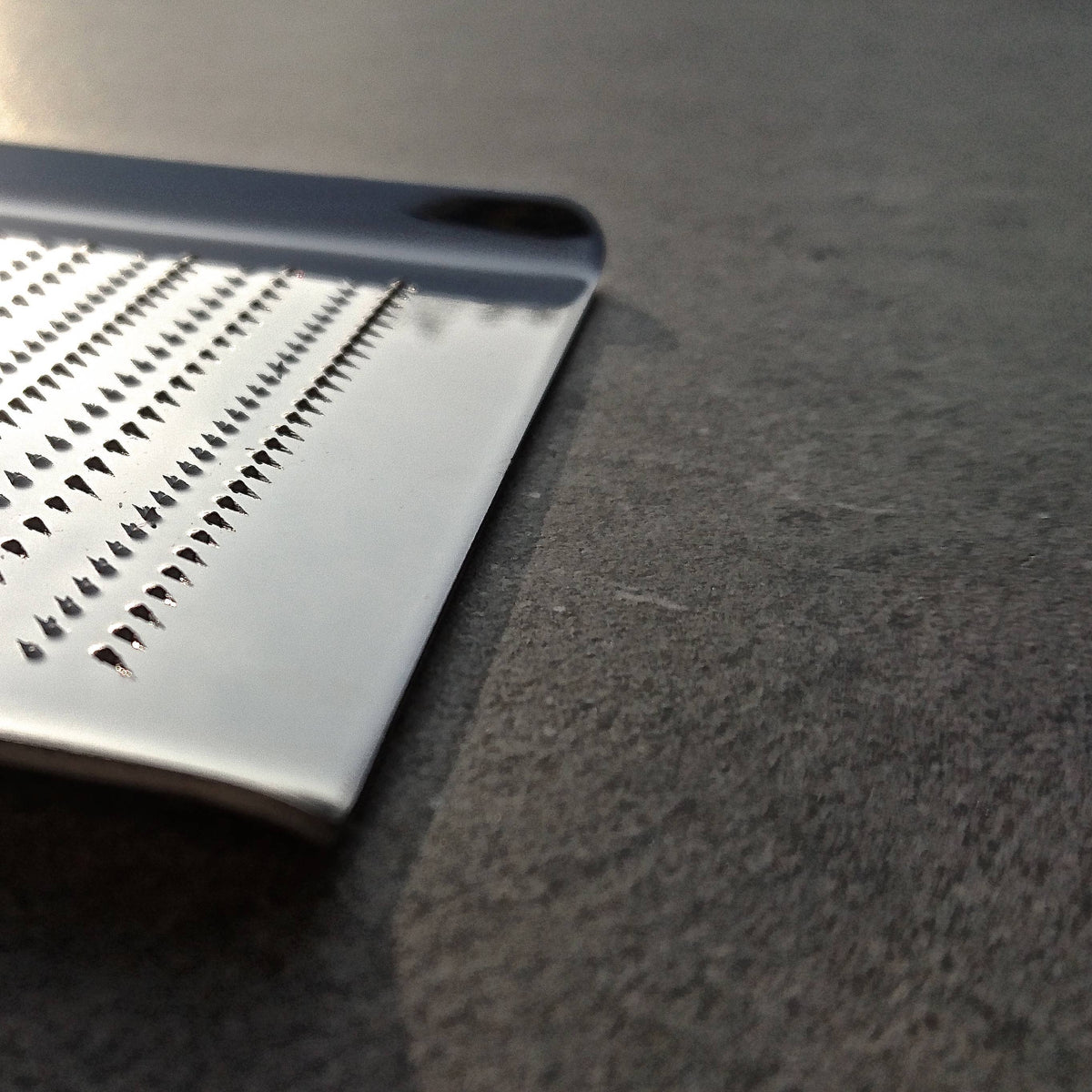 A close-up of a stainless steel grater