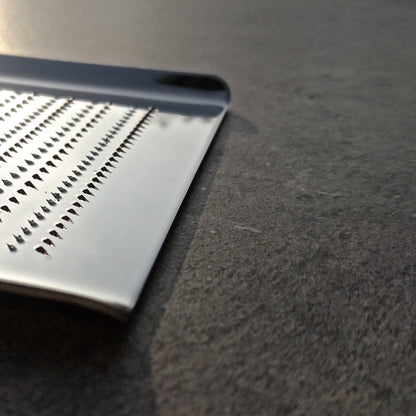 A close-up of a stainless steel grater