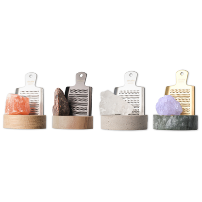 Set of four grating tools with different materials and colors on a white background