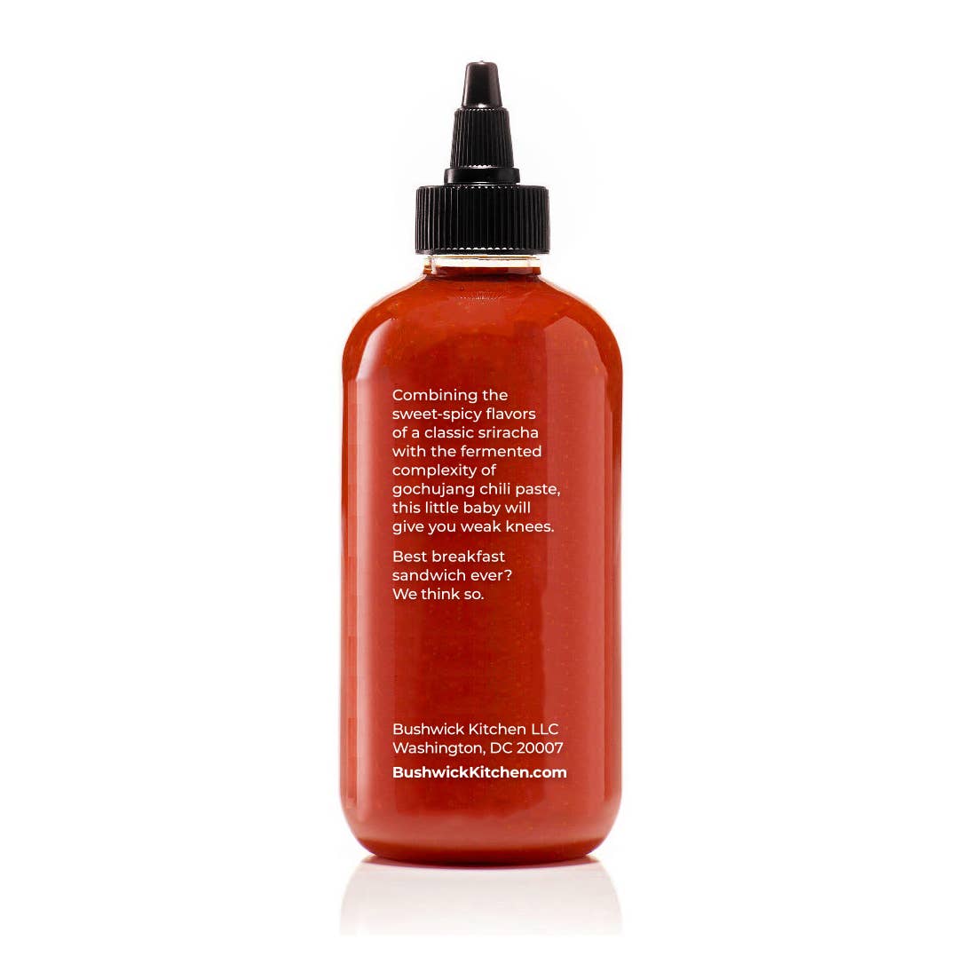 Red bottle with black cap on a white background