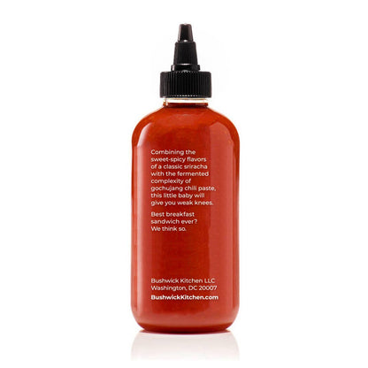 Red bottle with black cap on a white background