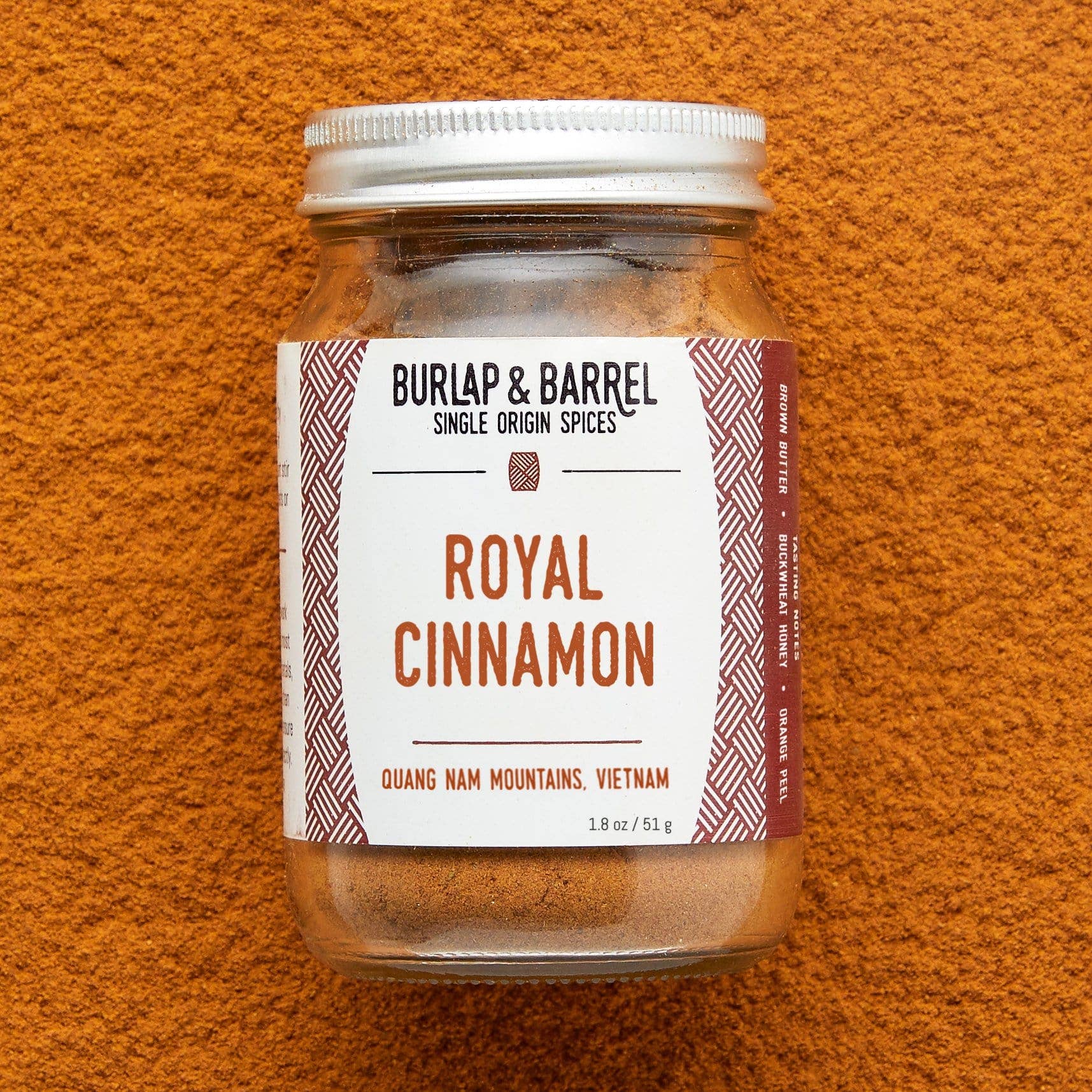 Jar of Burlap &amp; Barrel Royal Cinnamon on an orange background