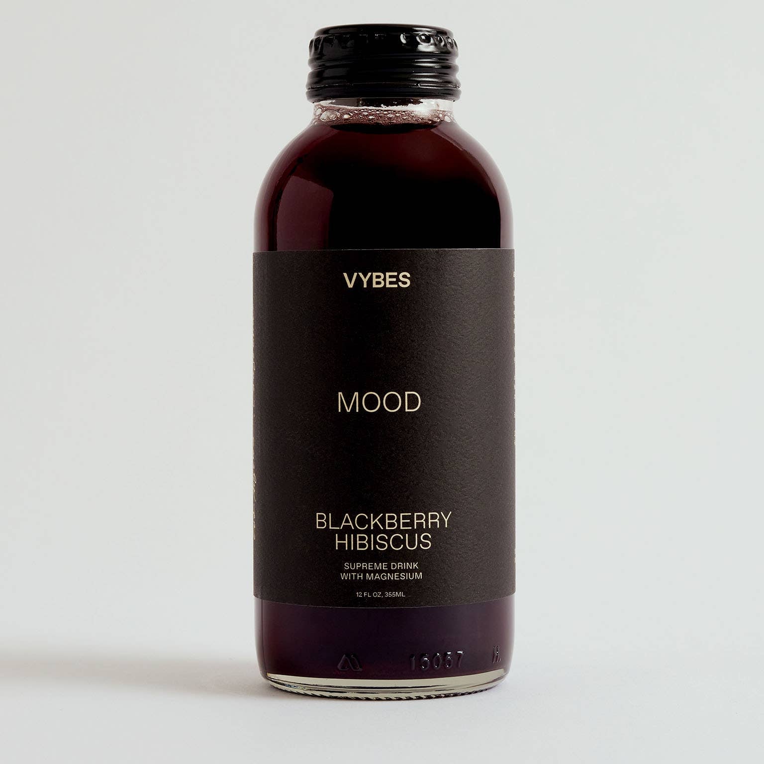 Bottle of VYBES Blackberry Hibiscus drink on a white background