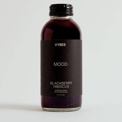 Bottle of VYBES Blackberry Hibiscus drink on a white background