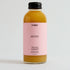 Bottle of VYBES Peach Ginger on a light gray background