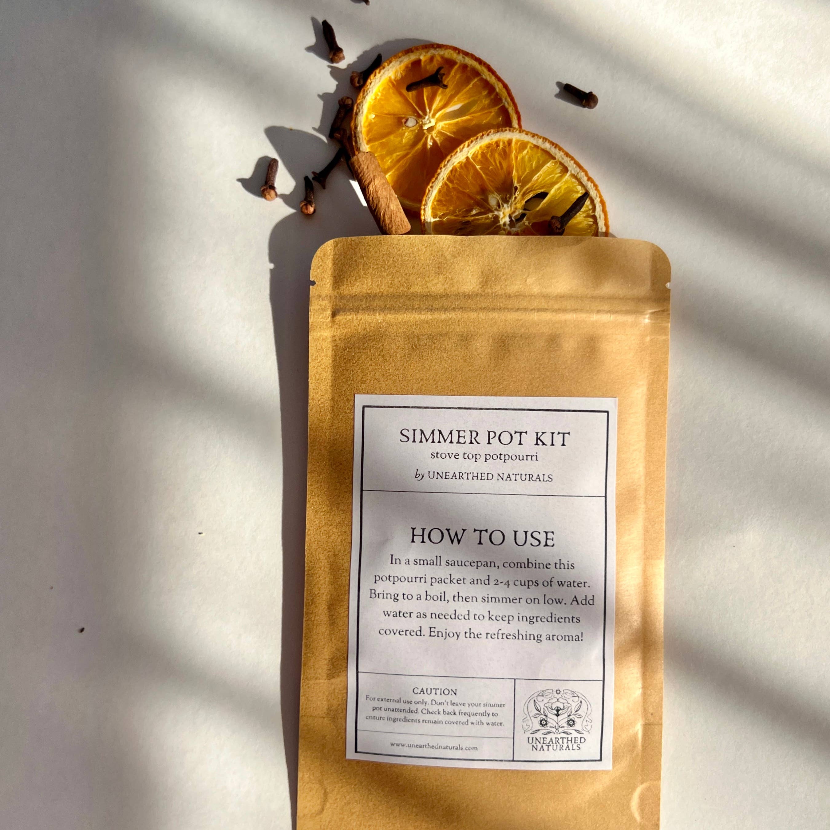 Simmer pot kit with dried orange slices on a light background