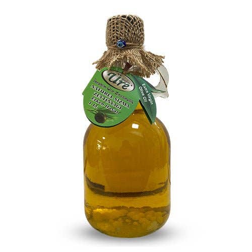 Bottle of olive oil with a green label on a white background