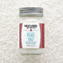 Jar of pearl salt with a Burlap & Barrel label on a textured white background