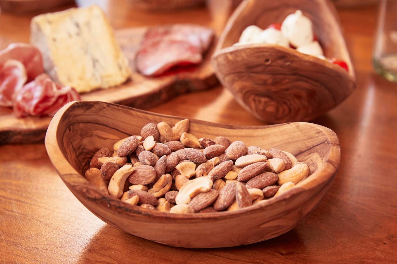 Italian Olivewood Serving Bowl filled with salted almonds and cashews