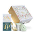 Tea packaging with floral design, tea scoop, and tea box on a white background