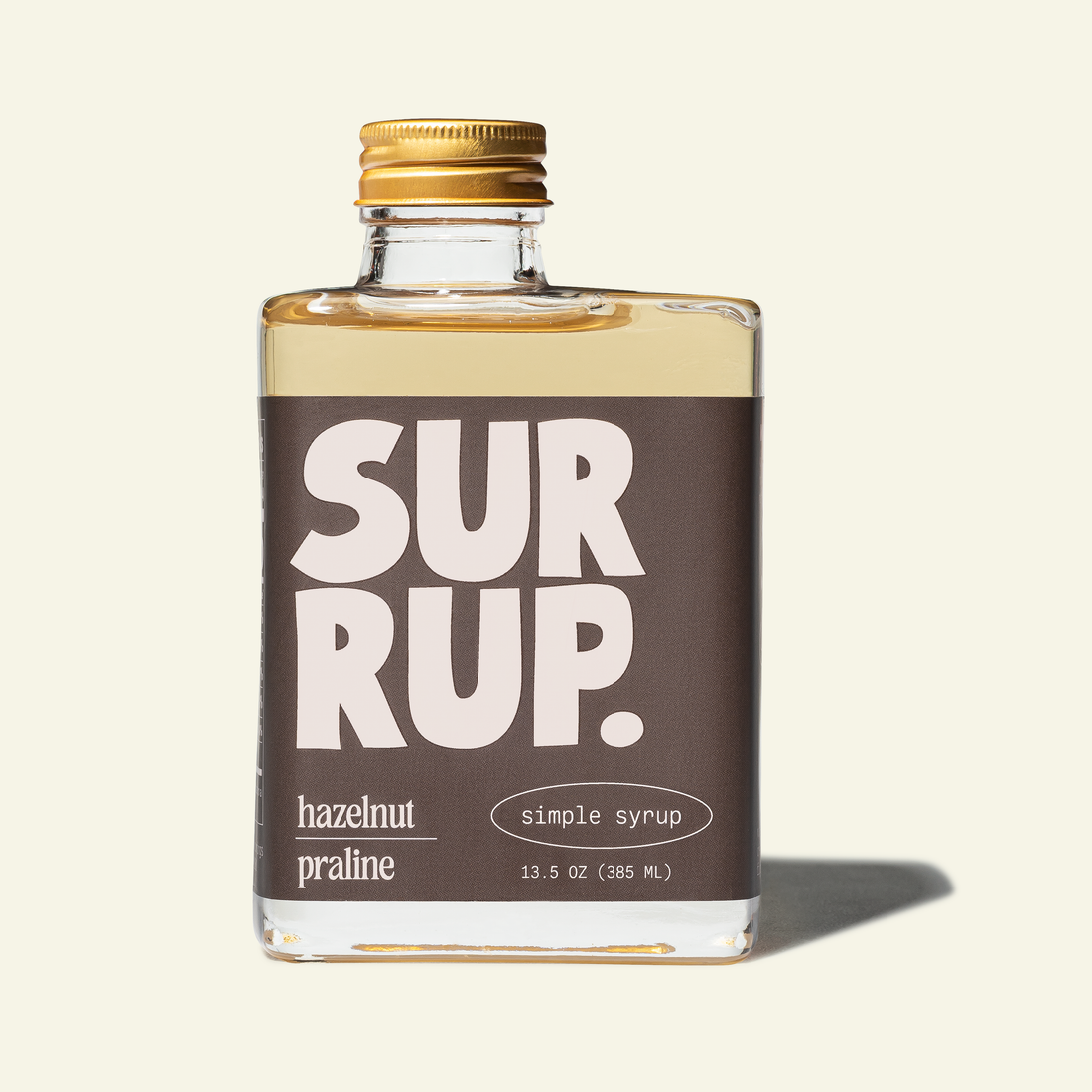 Bottle of SurRup hazelnut praline simple syrup on a white background