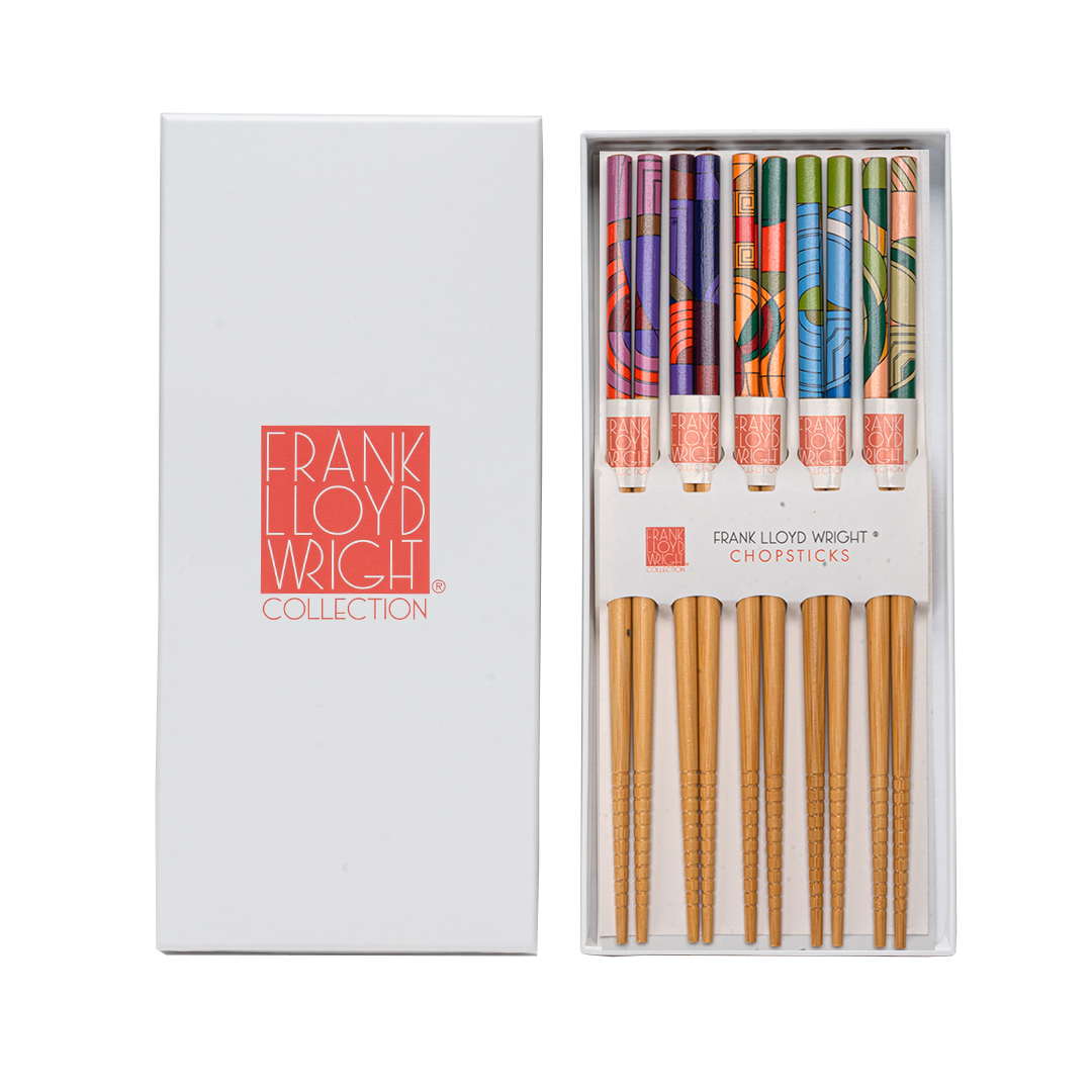 Set of chopsticks with colorful handles in a white box labeled &