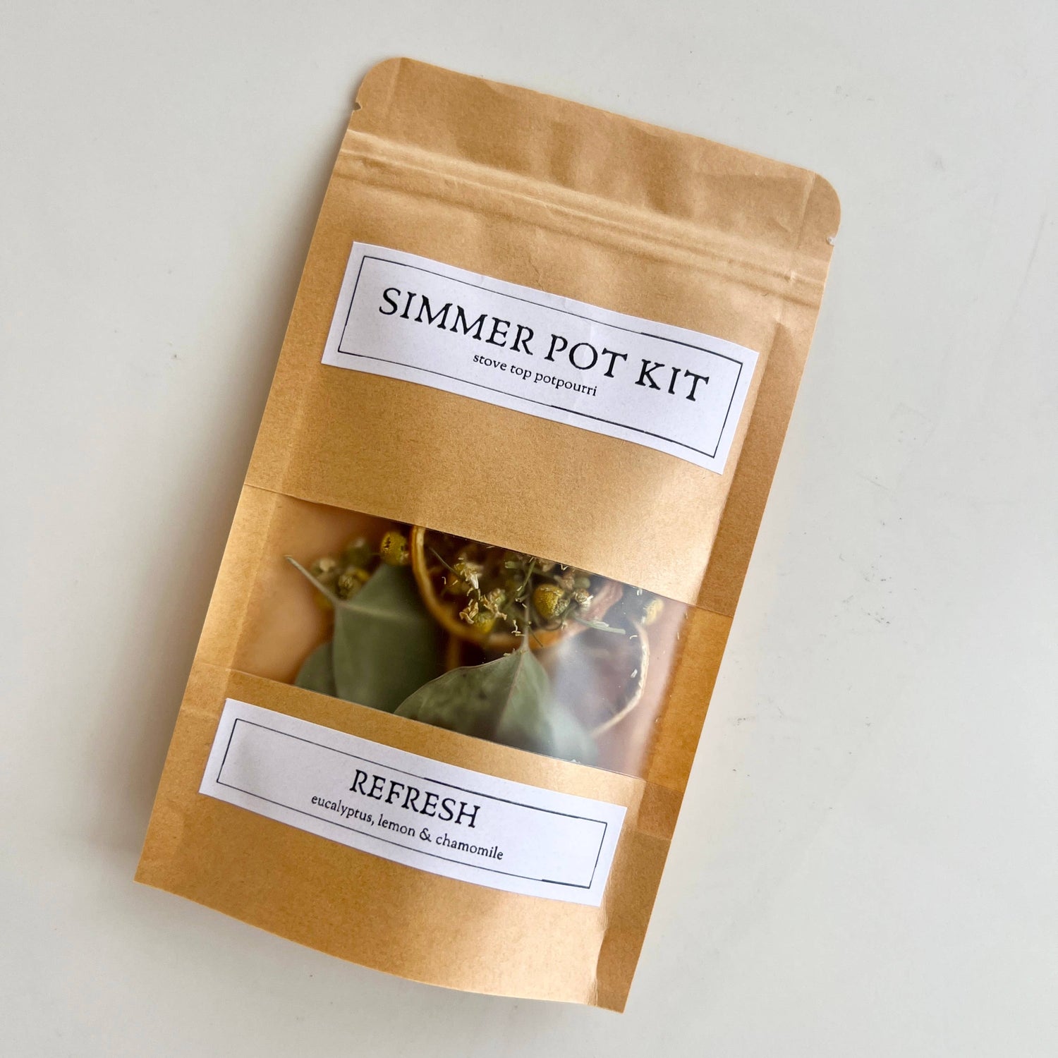 Simmer pot kit packaging with visible contents on a light background