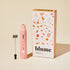 Pink milk frother with terrazzo patterned packaging on a beige background