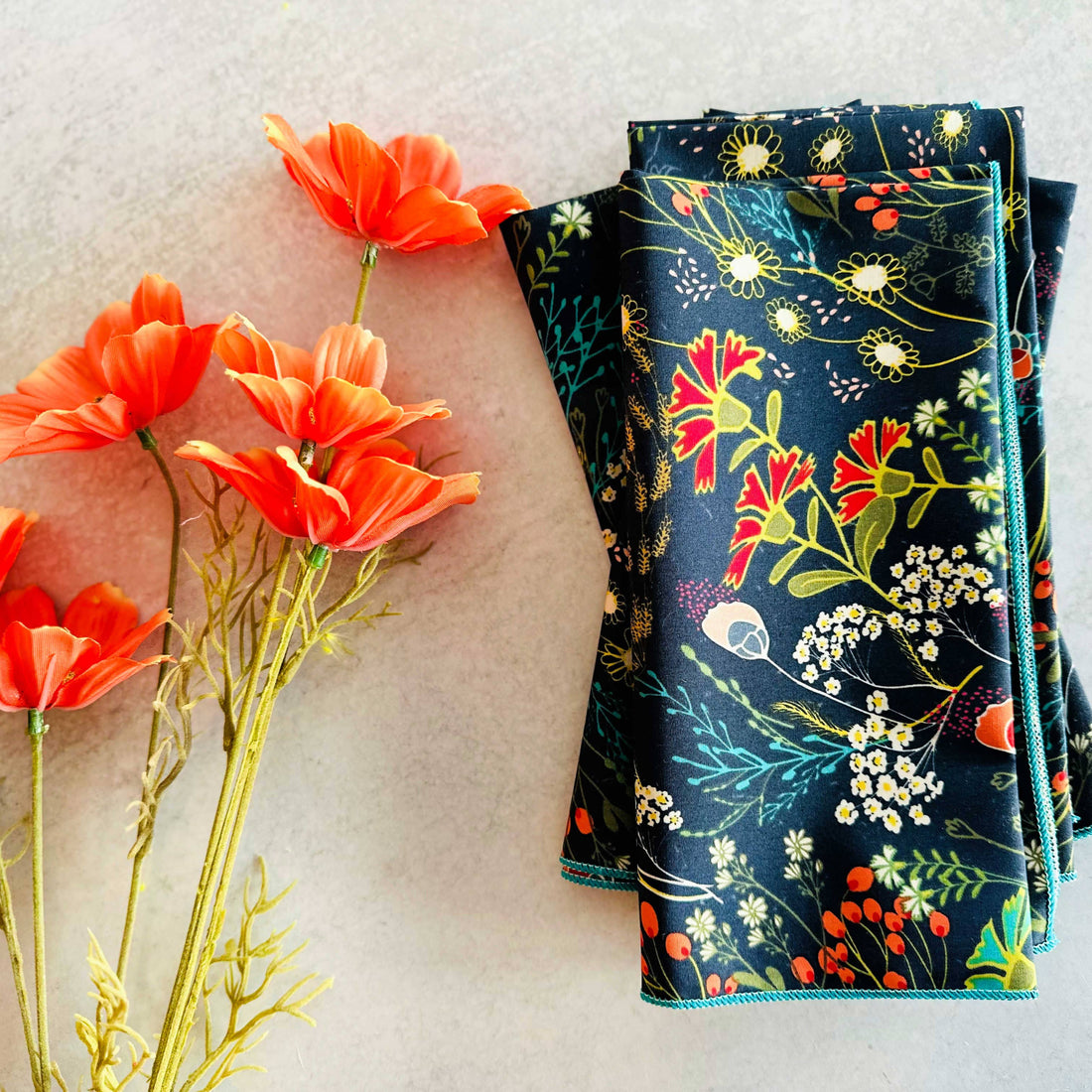 Floral-patterned fabric with red flowers on a textured surface