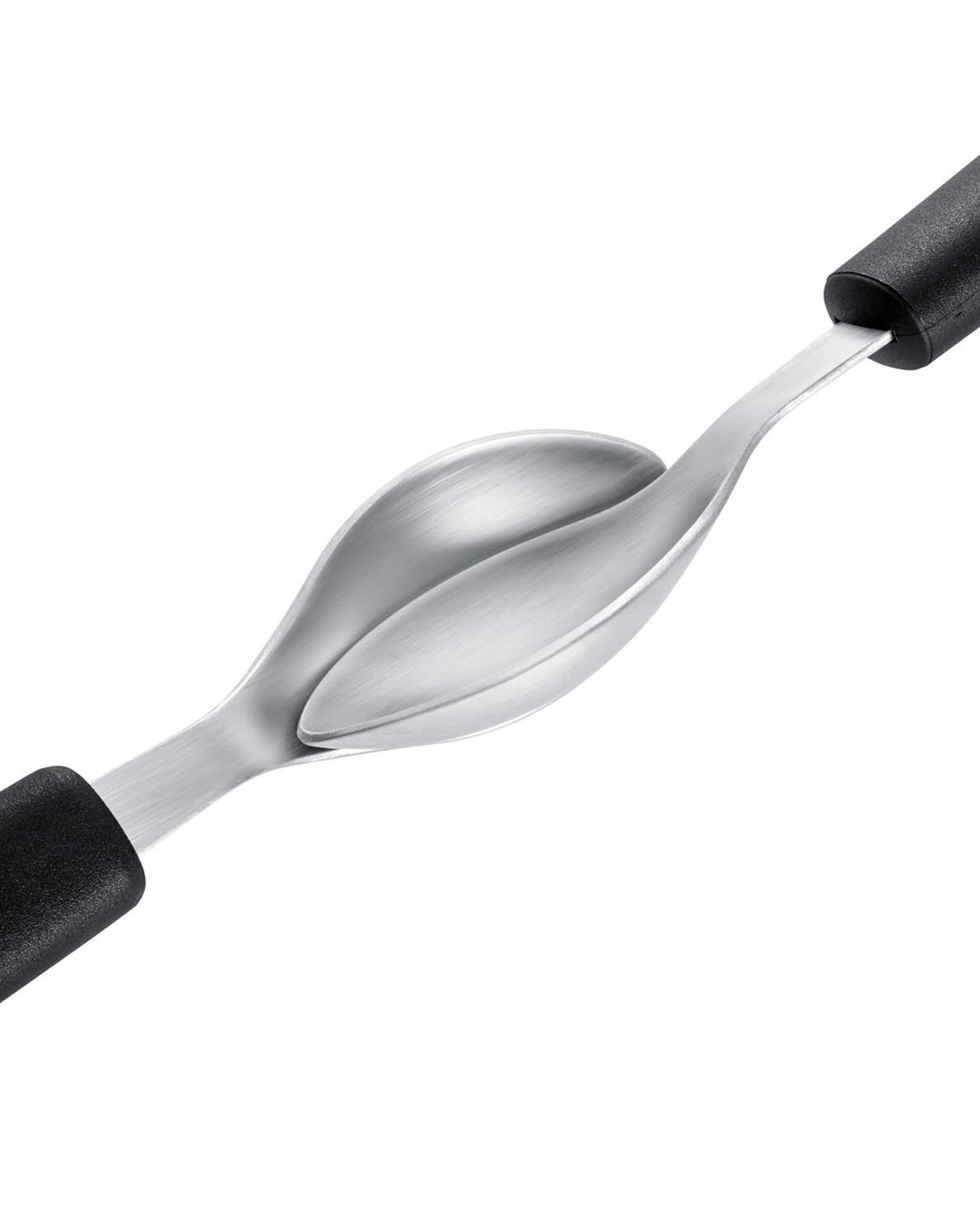 Two stainless steel quenelle spoons being scooped against each other
