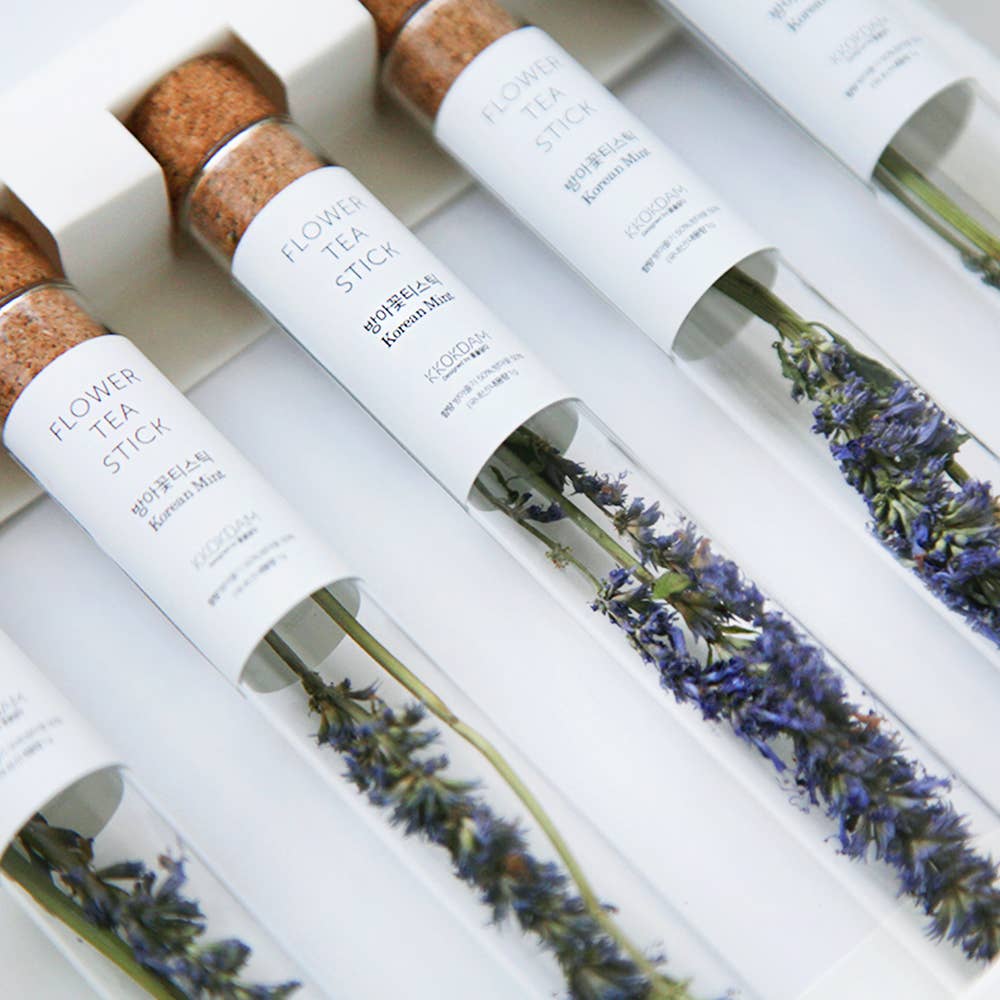 Flower tea sticks with lavender in white packaging on a light background