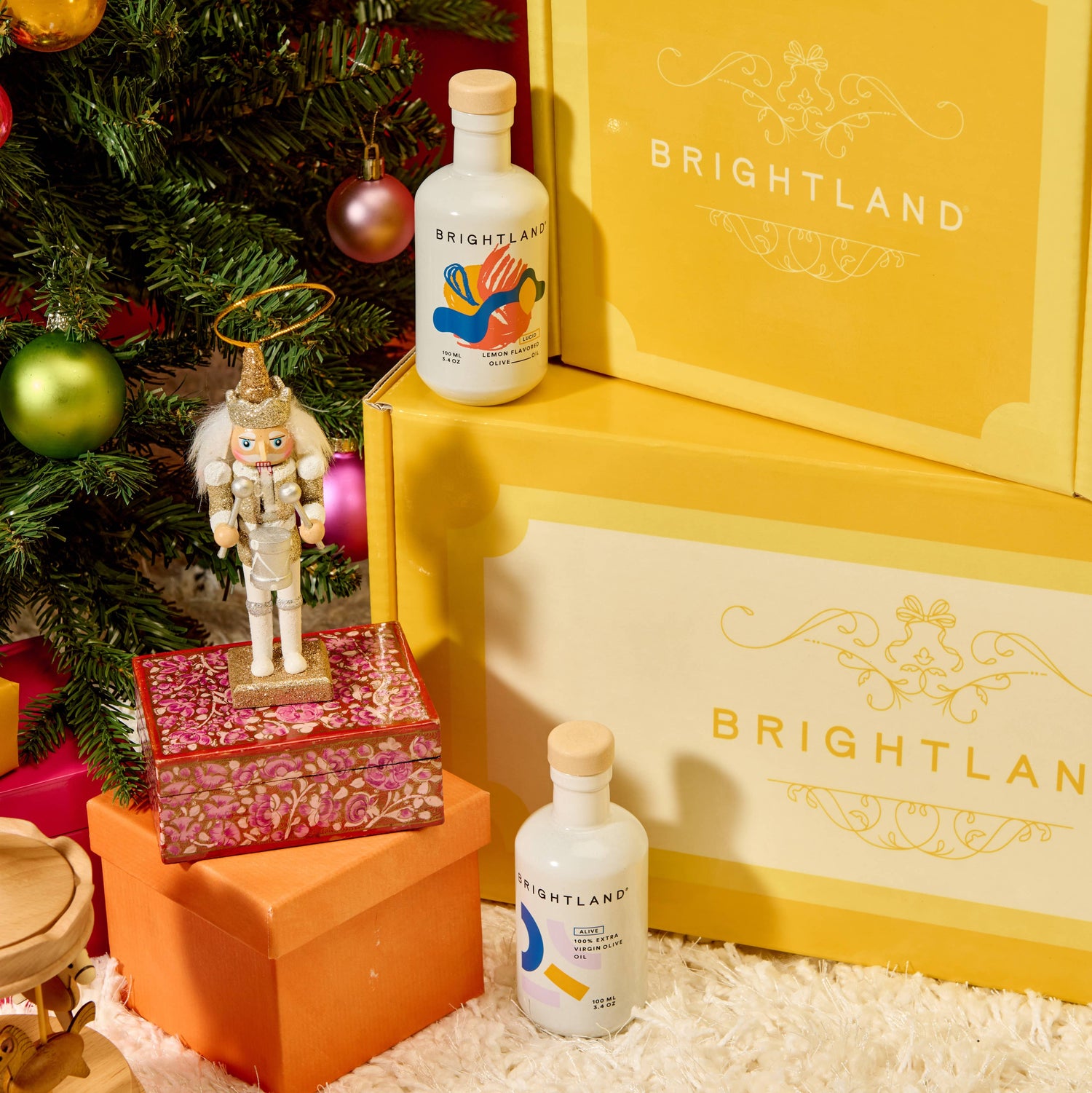 Bottle of Brightland chocolate on a decorative surface with a Christmas tree in the background