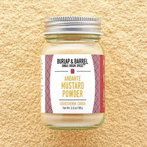 Jar of Andante Mustard Powder by Burlap & Barrel on a beige background
