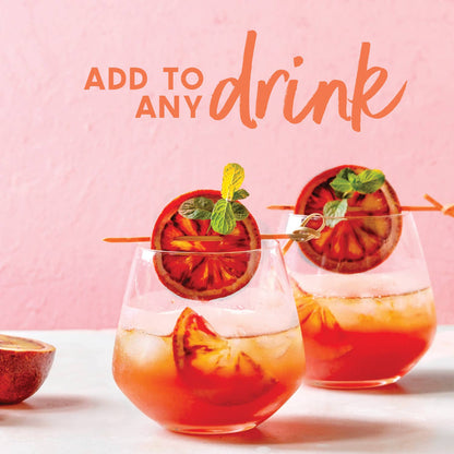 Two glasses of orange cocktails with garnishes on a pink background, text &