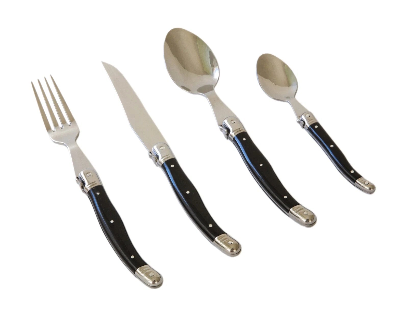 Set of silverware with black handles on a white background